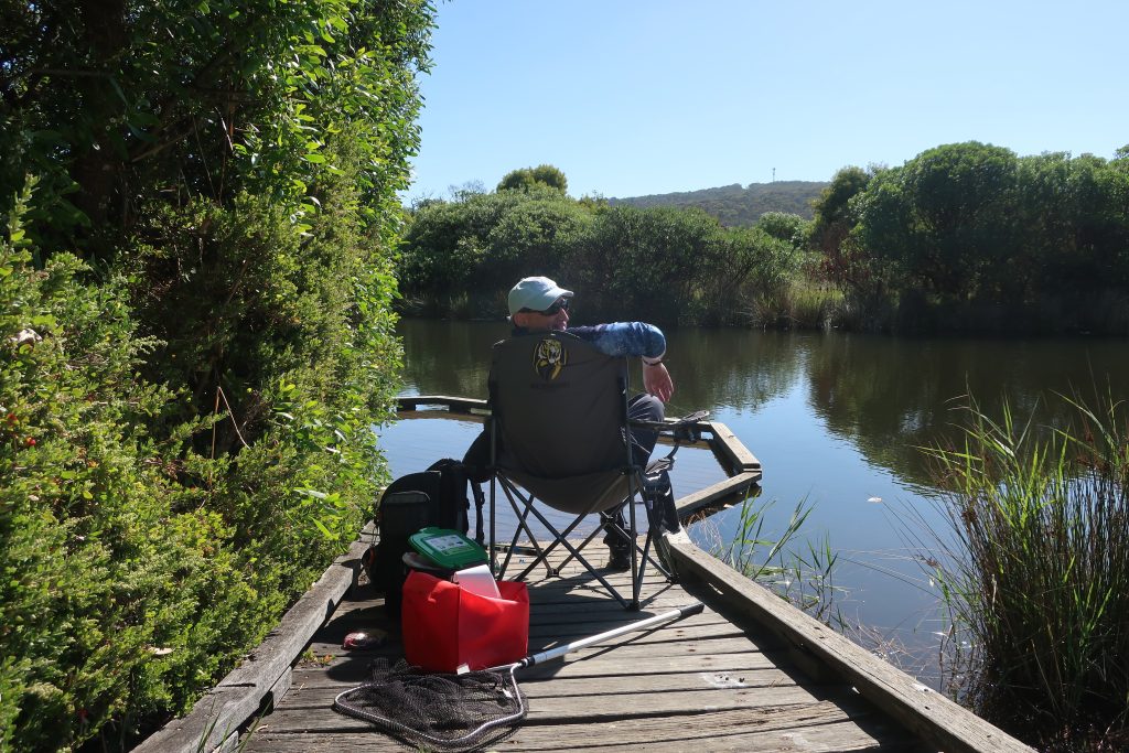 A person with disabilities enjoying some fishing while at Respite Care in Anglsea with Leisure Options.
