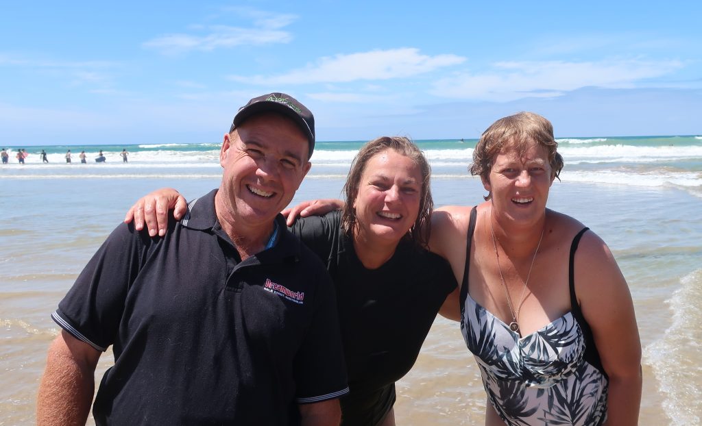 Two women and a man enjoying a break at the beach while at respite care with Leisure Options in Anglsea, Victoria.