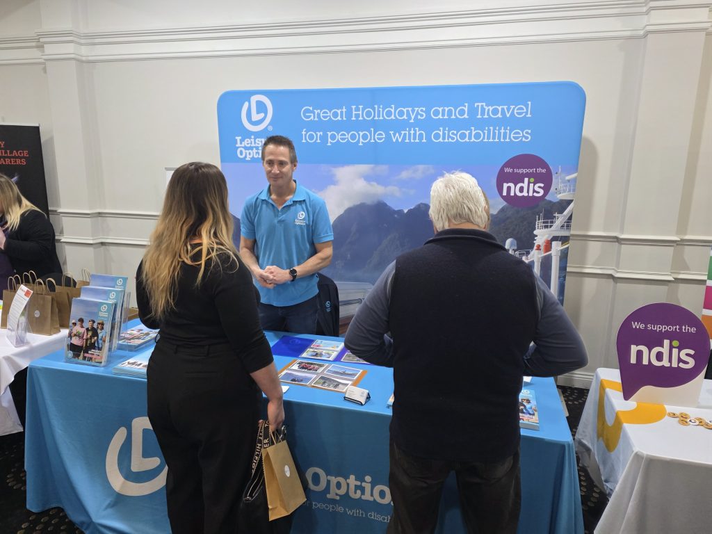 Gary speaking to people visiting the Leisure Options booth at the Bendigo Disability
